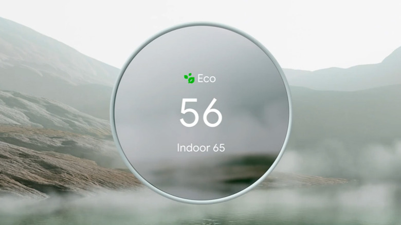 A Google Nest Thermostat against an outdoor background