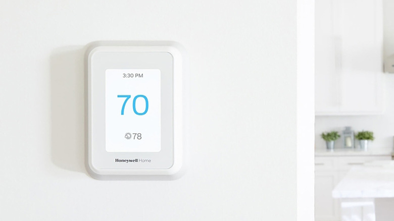 A Honeywell Home T9 on a white wall set to 70 degrees