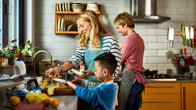 Family washing dishes and preparing food