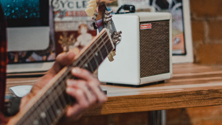 Spark Mini on table, guitar in the foreground