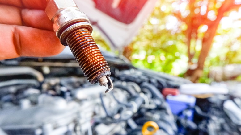 spark plug and car closeup