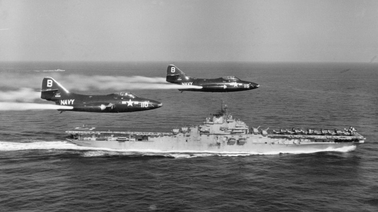 Two Navy F9F make a pass on USS Princeton.