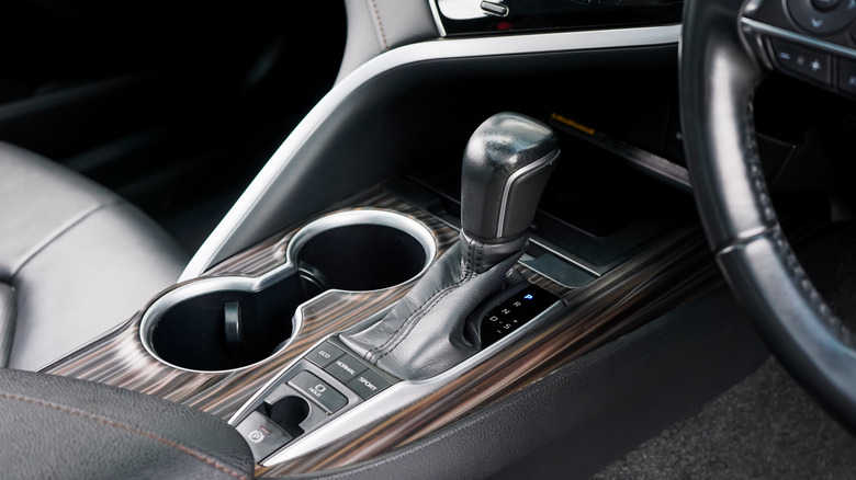 Black and wood-grained shifter module in a car