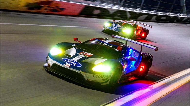 Two ford GT race cars on track at night