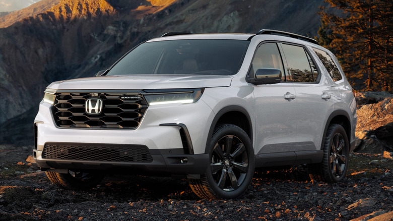 White Honda Pilot parked off-road