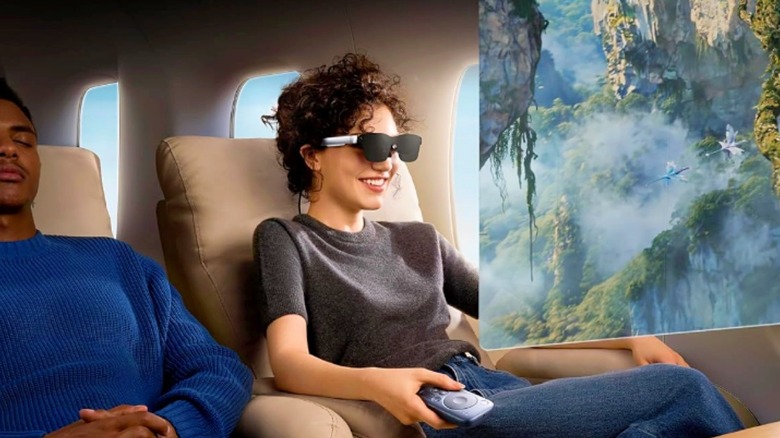 A woman watching a movie using the RayNeo Air 2S AR glasses while seated in an airplane.