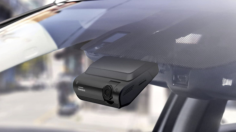 A Thinkware Q1000 Dash Cam surveilling through a car windscreen.