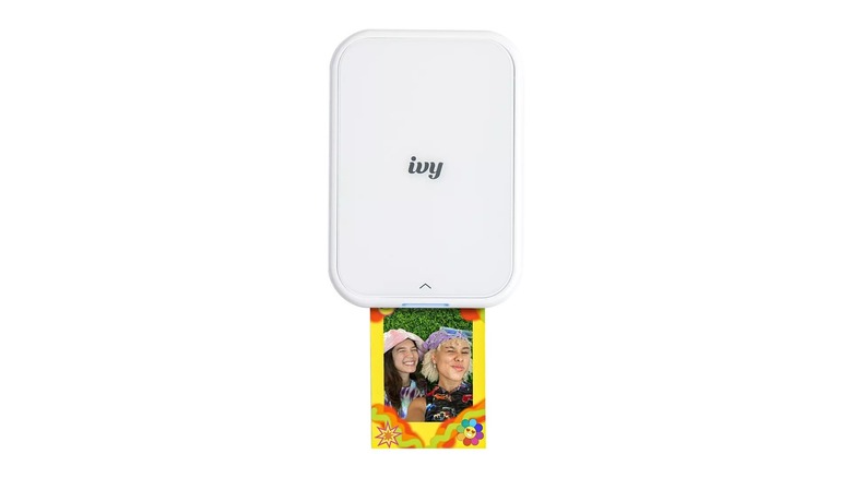 White rectangular device printing a colorful photo of two people