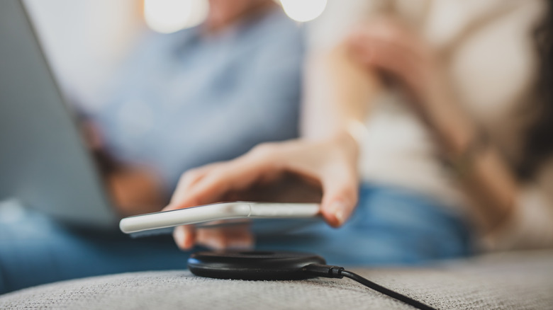 Person using a wireless charger