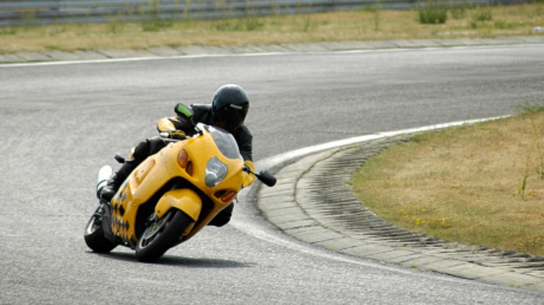 Man riding a Hayabusa on a race track