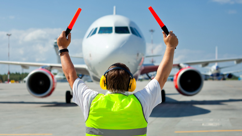 Ground crew signaling plane