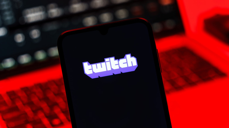 Smartphone with Twitch logo in front of laptop