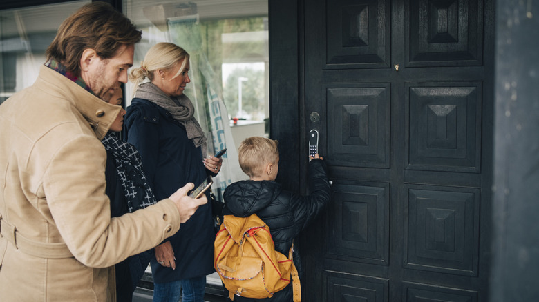 People entering their home with a smart lock code