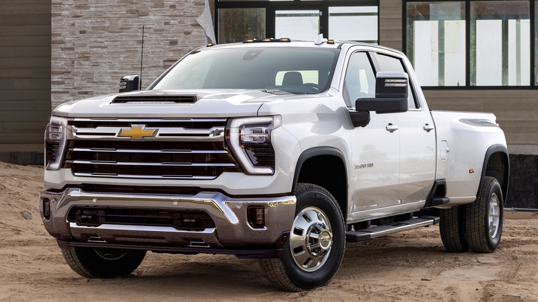 The 2024 Silverado HD in white, front 3/4 view