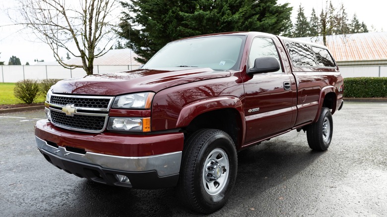 A second generation Silverado HD in burgundy, front 3/4 view, hardtop