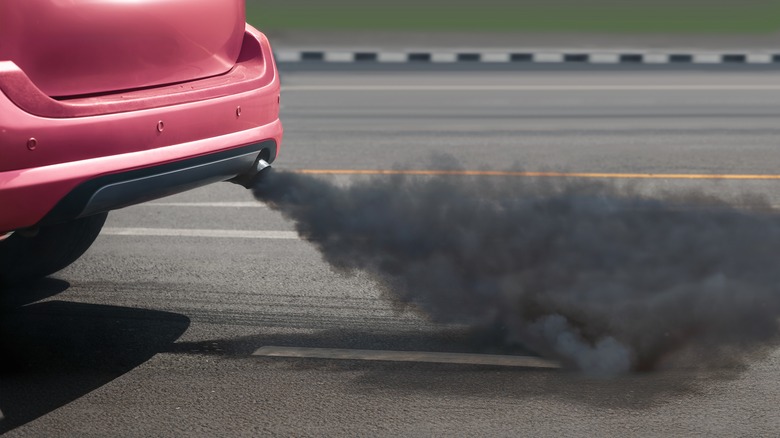 Dark exhaust coming out the back of a sedan