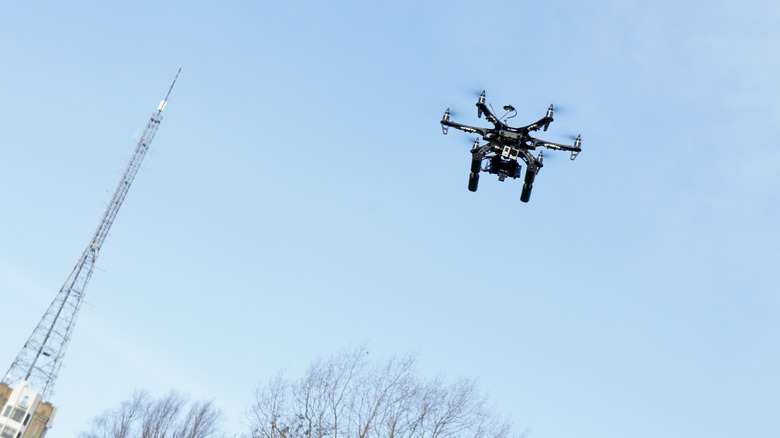 Drone flying next to a tower