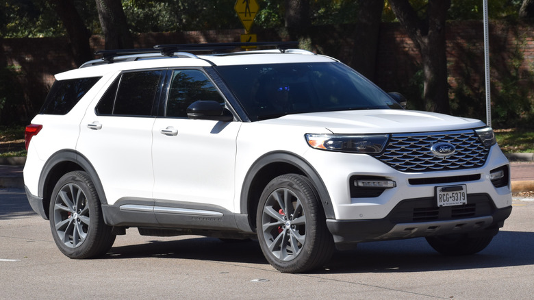 White Ford Explorer cruising down road