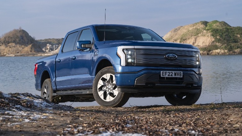 a blue ford f-150 next to a lake