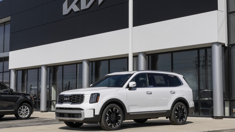 White Kia Telluride outside dealership