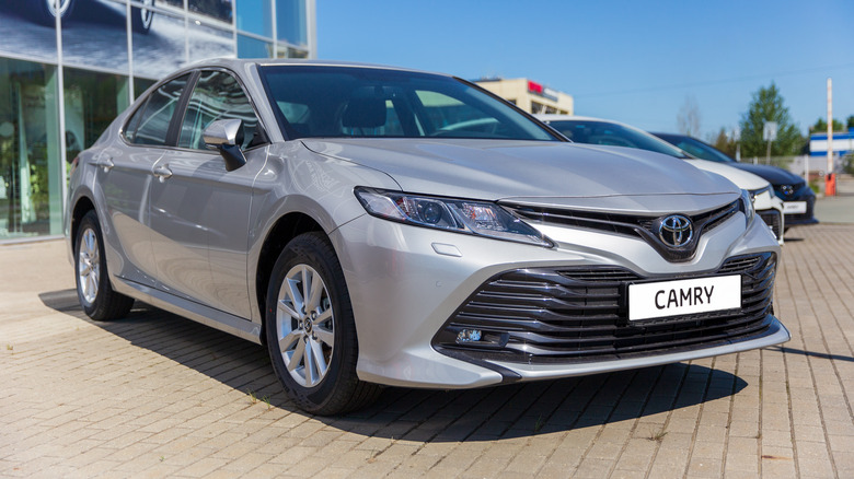 Toyota Camry in front of motor show