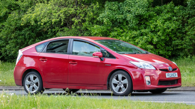 Red 2011 Prius on a road