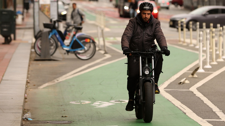 Man riding eBike down street