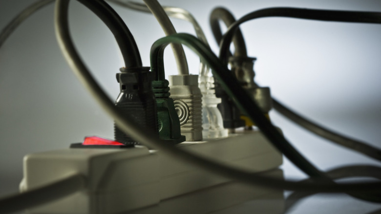 A power strip filled with plugs for various things