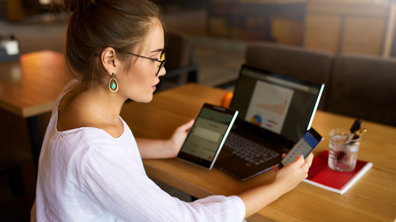 Woman holding tablet and smartphone