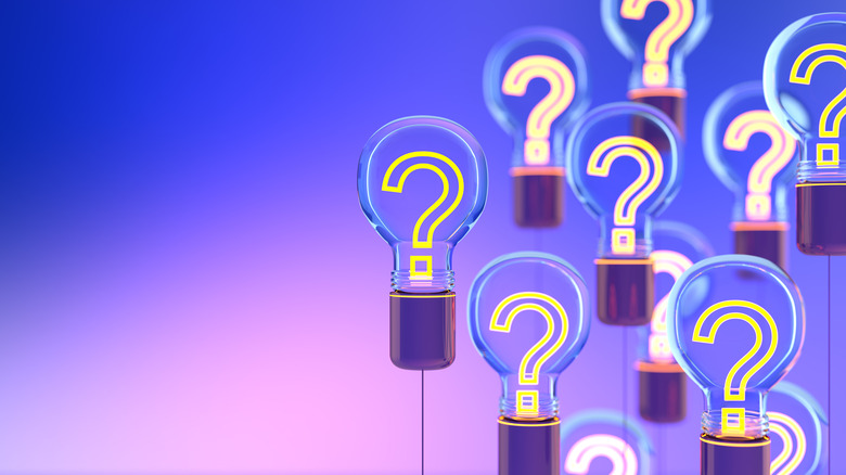 neon yellow question marks in light bulbs