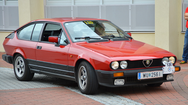 The Alfa Romeo Alfetta GTV in two-tone red and black, front 3/4 view