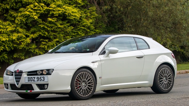 The Alfa Romeo Brera in white driving, front 3/4 view