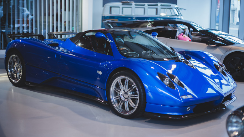 The Pagani Zonda F in blue at a car dealership, front 3/4 view