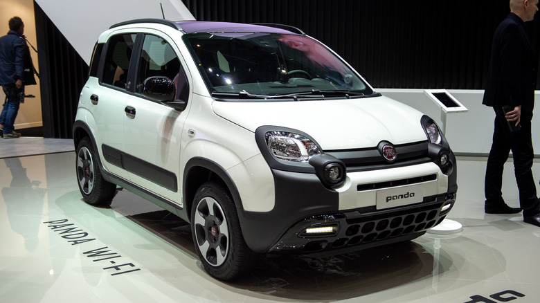 The Fiat Panda 4x4 in white at an auto show, front 3/4 view