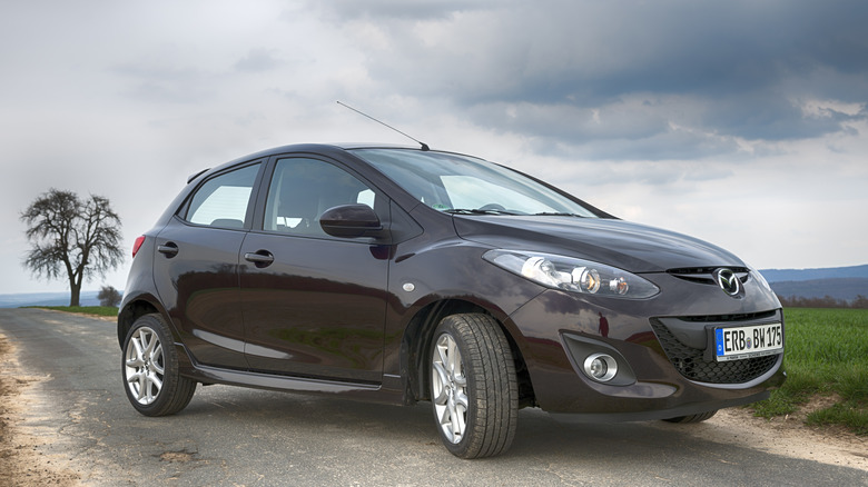 The Mazda 2 in dark burgundy, front 3/4 view