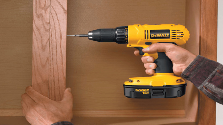 a close view of a worker using the Compact Drill/Driver Kit (DC720KA)