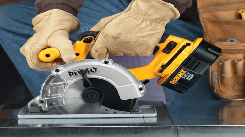 Metal Cutting Circular Saw being used by worker on a metal surface