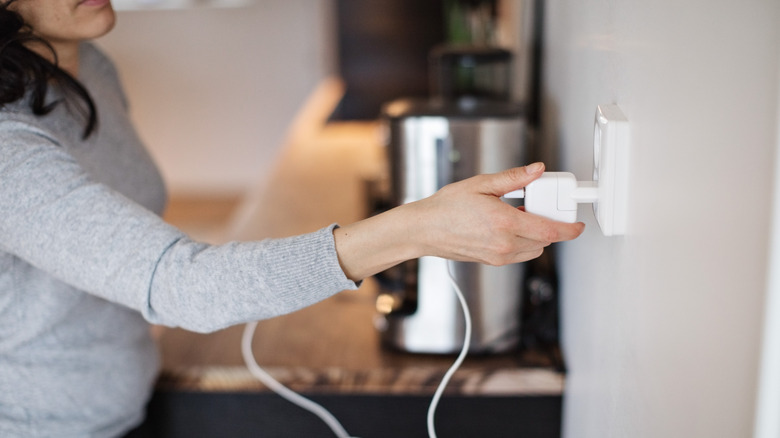 A person plugging in a charger