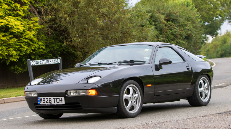 1995 Black Porsche 928 driving on a country road