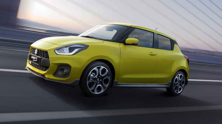 Yellow 2023 Suzuki Swift Sport driving