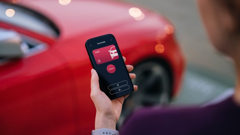 A person opening a car with their phone