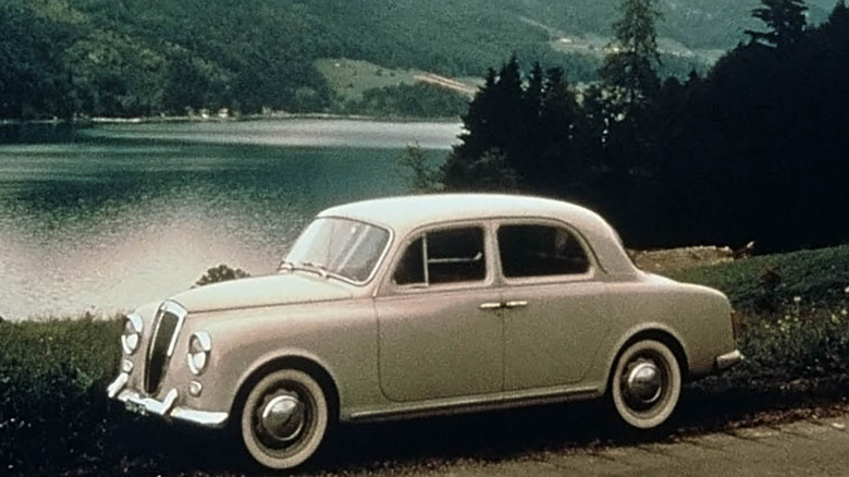 Lancia Appia front 3/4 view with lake and mountains in the background