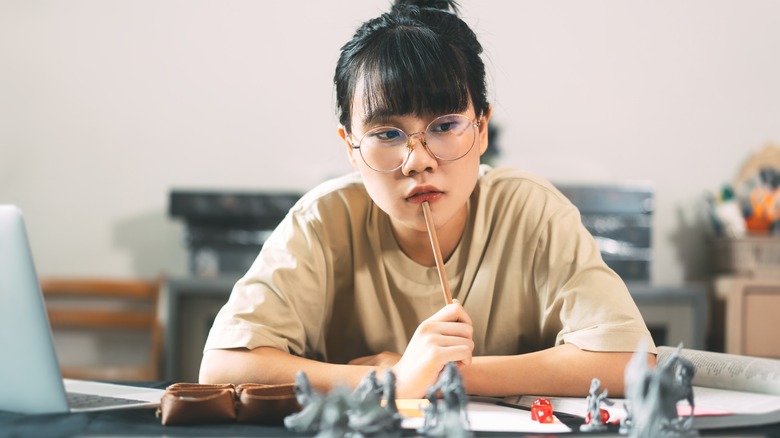 woman with miniatures and dice