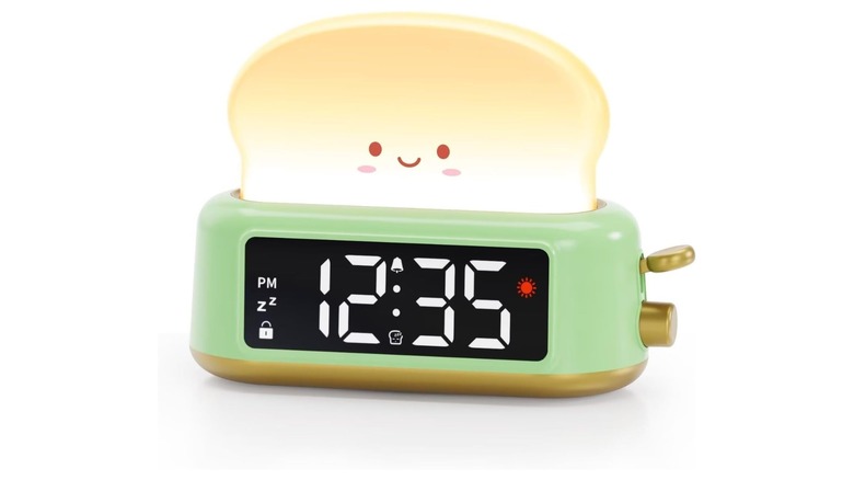 Cartoonish toaster with a green base and glowing piece of smiling toast