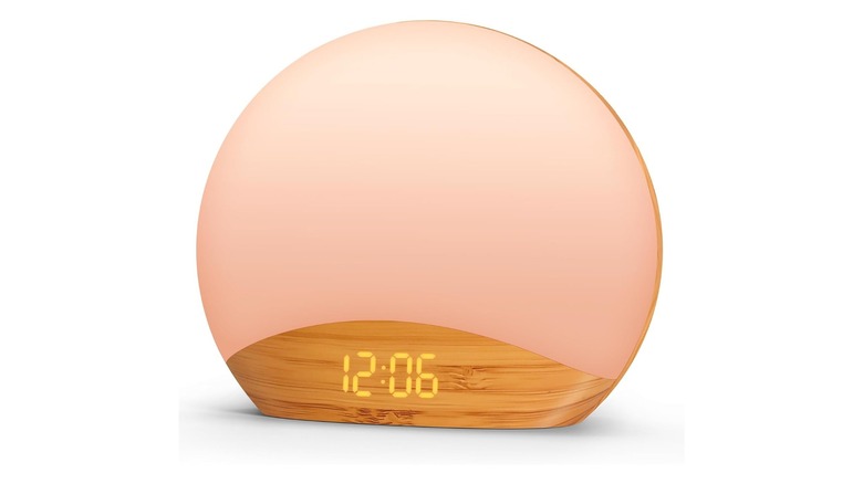 Mostly-round clock with a wood-grain base displaying the time 12:06