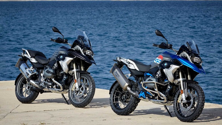 Two R 1200 GS motorcycles parked by the ocean