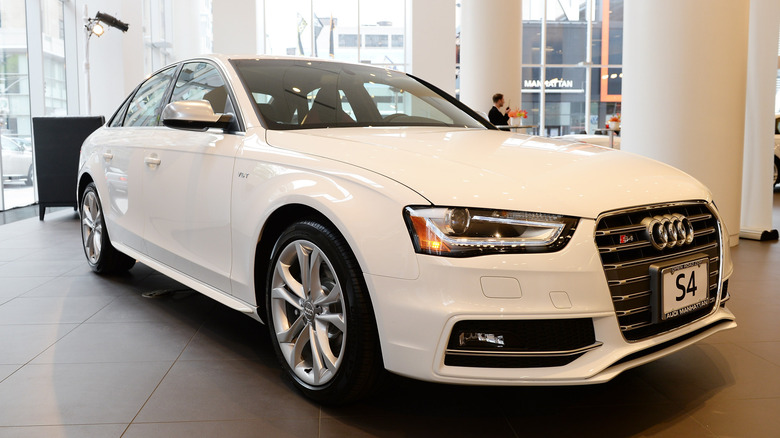 The B8 Audi S4 in white at a dealership, front 3/4 view