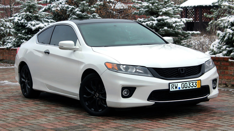 An eighth generation Honda Accord Coupe in white, front 3/4 view