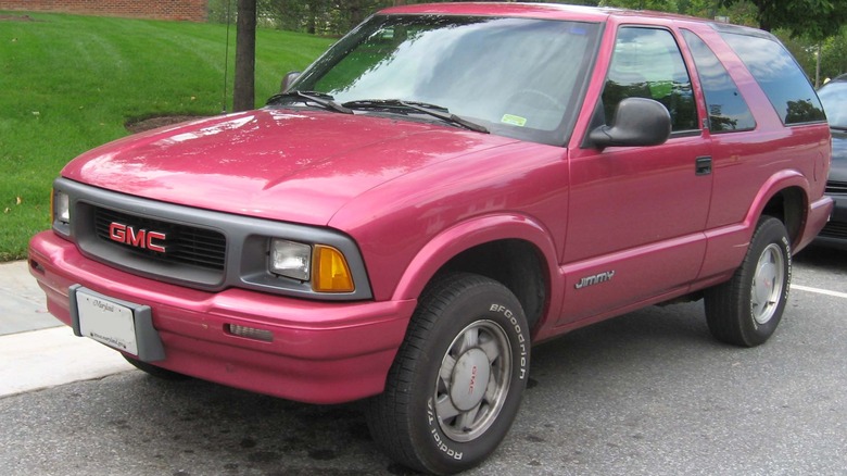 Pink 1995 GMC Jimmy parked