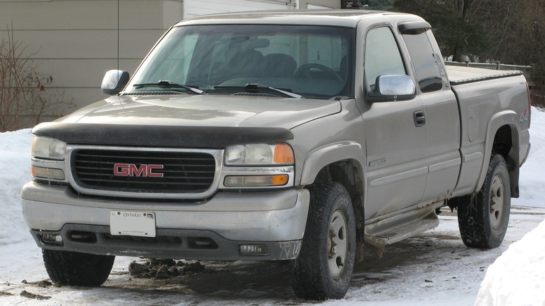 Gray 1999 GMC Sierra parked in snow